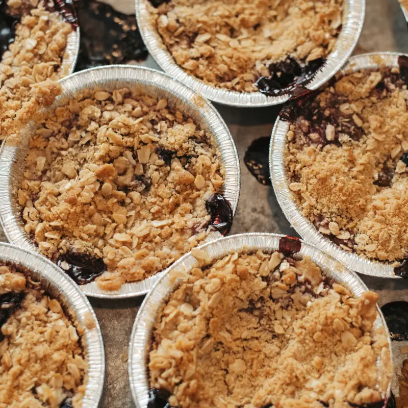 Individual berry crisps with an oat crumble topping, fresh from the oven