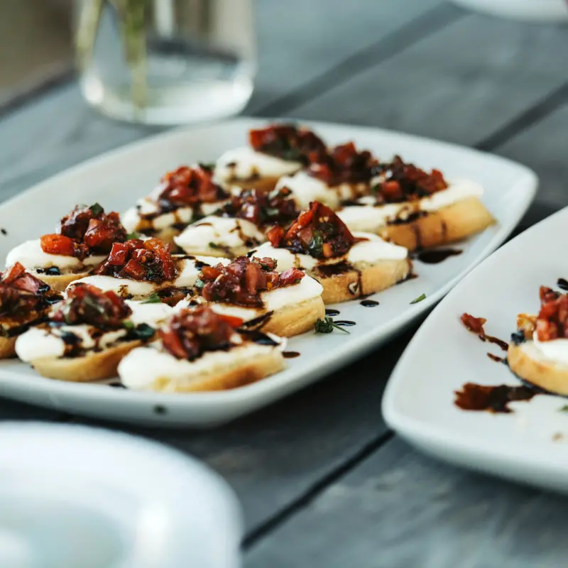 Platters of bruschetta with tomato and soft cheese on toasted bread